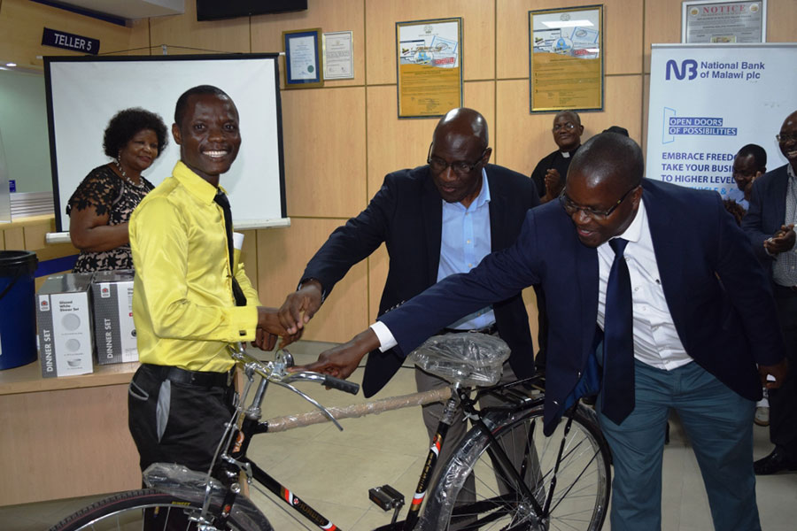 A lucky customer walks away with a bicyle during the raffle draw