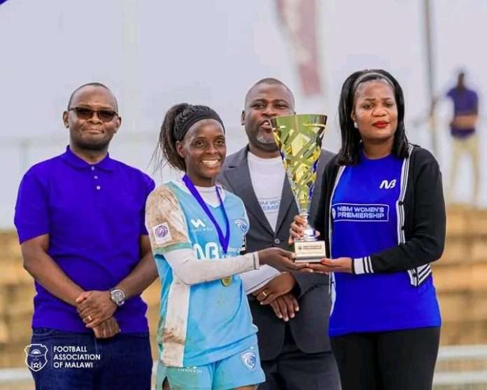 Wiskies presenting the trophy to Silver Strikers Ladies captain Nyirongo
