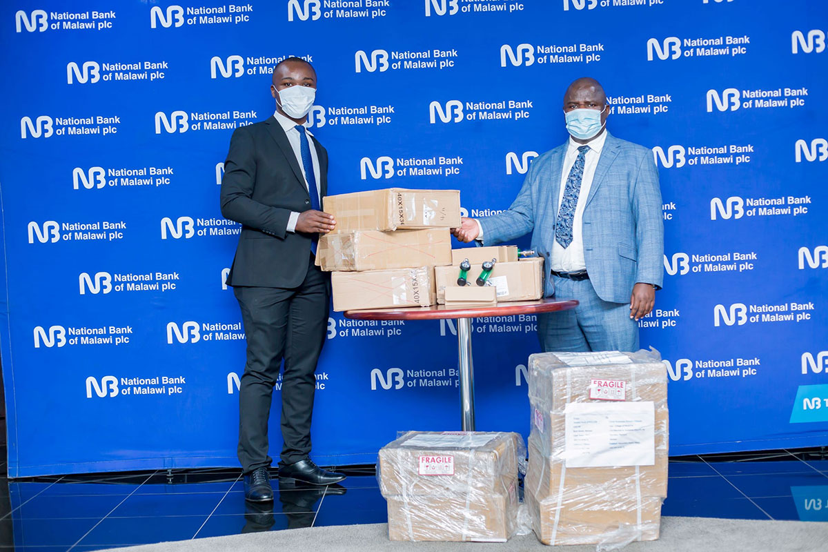 Dulira (right) presents some of the items to Mbizi Dulira (right) presents some of the items to Mbizi