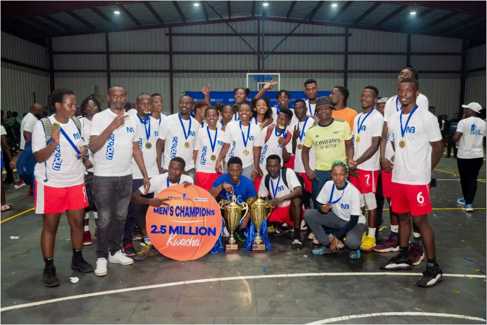 Triumphant - Magu Wolves and Magu she-wolves players and officials pose with their trophies Triumphant- Magu Wolves and Magu she-wolves players and officials pose with their trophies