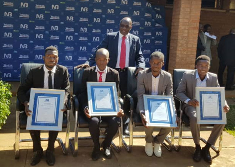 Kawawa (standing) poses with the best students